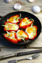 Selective focus. Red peppers with eggs baked in a frying pan. The keto diet. Keto lunch idea.