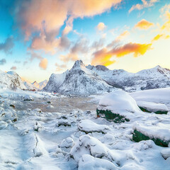 Obraz premium Picturesque frozen Flakstadpollen and Boosen fjords with cracks on ice during sunrise with Hustinden mountain on background on Flakstadoya island