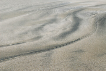 Abstract sand patterns by the sea shore