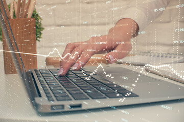 Multi exposure of woman hands typing on computer and forex chart hologram drawing. Stock market analysis concept.