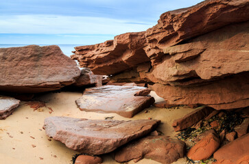 At Cavendish beach, on Canada's Prince Edward Island, the flat red sandstone is layered ontop of each other and piled with yellow sand to created a serene pattern.