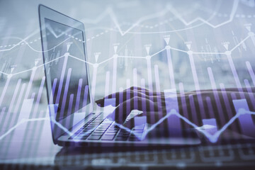 Double exposure of woman hands typing on computer and forex chart hologram drawing. Stock market analysis concept.