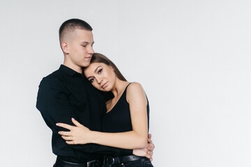 Views of a loving couple on a white background. Look at each other. Love. Kisses. The guy kisses his wife.