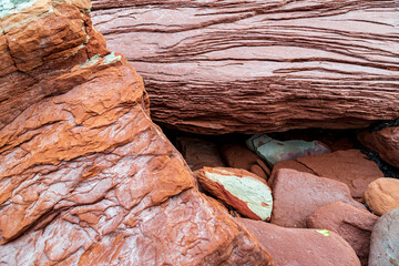 At Cavendish beach, on Canada's Prince Edward Island, the flat red and turquoise sandstone is...