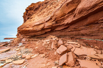 At Cavendish beach, on Canada's Prince Edward Island, the flat red and turquoise sandstone is covered with fallen rocks caused by erosion