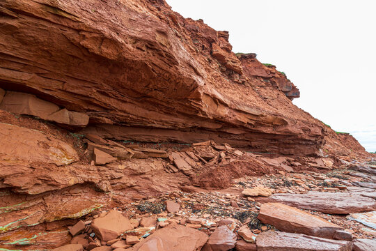 At Cavendish beach, on Canada's Prince Edward Island, the flat red and turquoise sandstone is covered with fallen rocks caused by erosion
