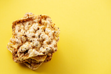 Corn crackers isolated on yellow background.