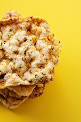 Corn crackers isolated on yellow background.