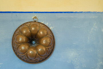old cake mold on a kittchen wall