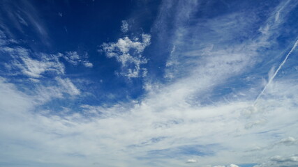 Naklejka na ściany i meble Cloudscape with cirrus clouds against blue sky