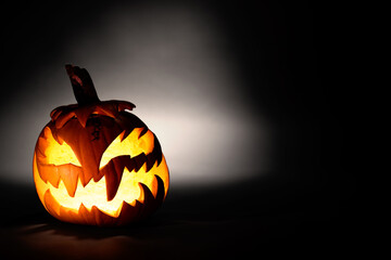 halloween pumpkin on dark background glowing pumkin with spooky face