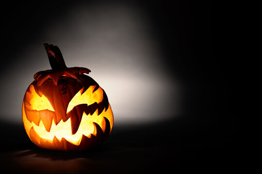 Halloween Pumpkin On Dark Background Glowing Pumkin With Spooky Face