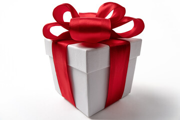 White gift box with red ribbon bow