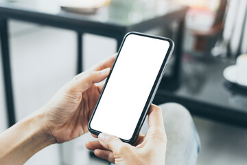 cell phone mockup blank white screen.woman hand holding texting using mobile on desk at coffee shop.background empty space for advertise.work people contact marketing business,technology