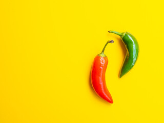 red and green hot chili peppers on yellow