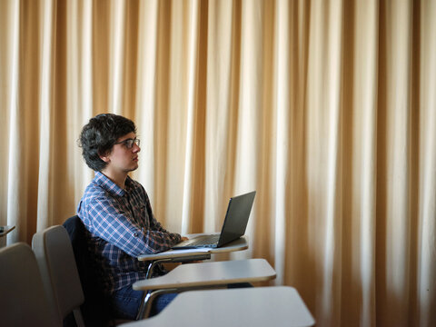 Student with computer at classroom