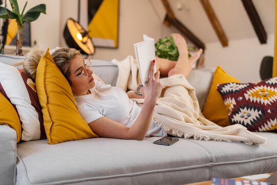 Woman In A Cozy Room Reading A Book