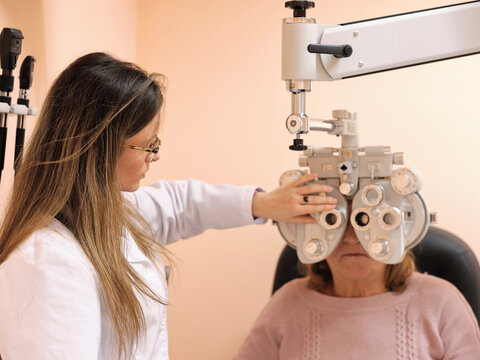 Young optometrist examining pacient