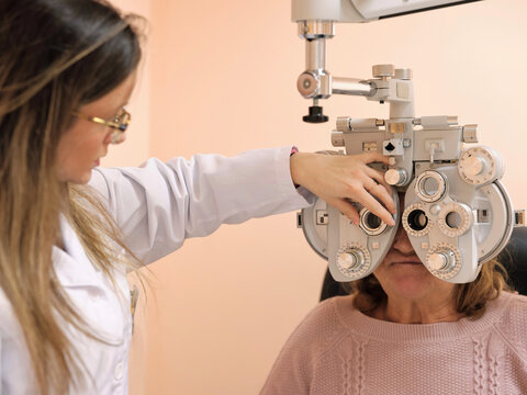 Young optometrist examining pacient