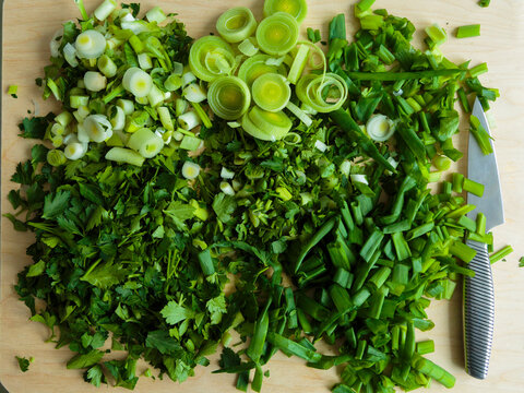 Various chopped herbs on cutting board
