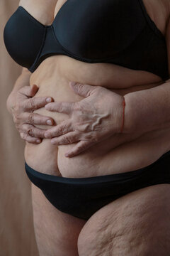 Crop obese woman touching belly