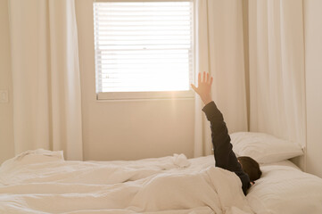 A Boy Stretching In Bed