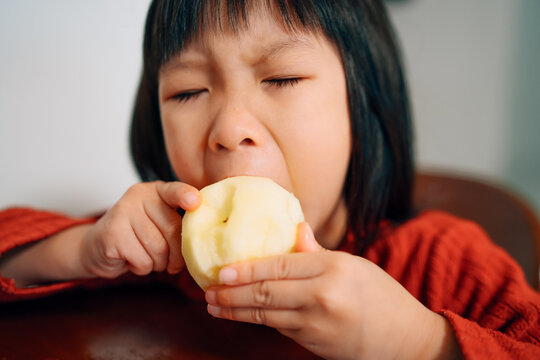 Little girl eating apple