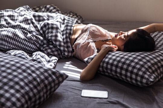 Shadow play - portrait of woman in bed waking up