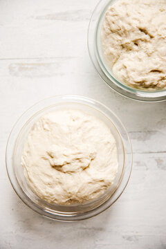 bread dough rising in glass bowls