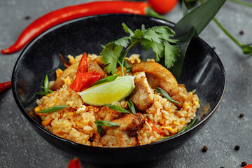 Thai rice with chicken. Thai dish of rice, chicken, Yalta onion, corn, pineapple, tomato, soy sauce, chili paste, cilantro, lime, chili pepper