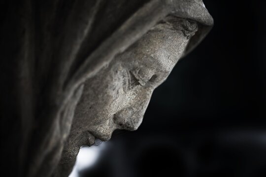Side portrait of a Madonna, sculpture, grave in the cemetery