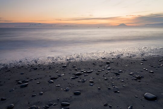 View towards volcanic mountains from the beach at Whiskey Gulch, left, Mount Iliamna, and right, Mount Redoubt, Cook Inlet, Aleutian Range, Alaska, USA, North America
