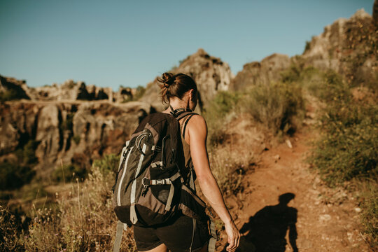Woman with backpack hiking in forest