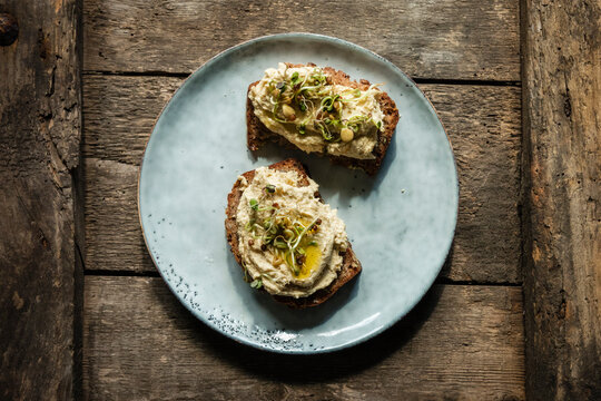Bread slices with hummus and sprouts