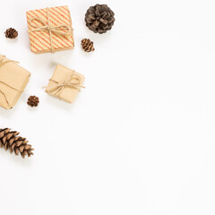 Gift boxes with pine cones on white background. Autumn and winter concept. flat lay, top view, copy space