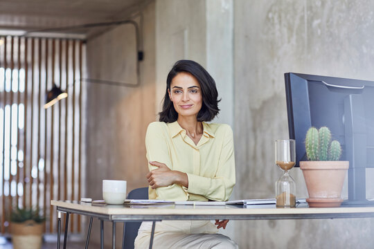 Businesswoman contemplating while sitting at desk in office