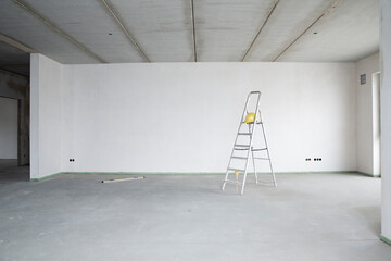 Ladder with hardhat against wall in renovating house
