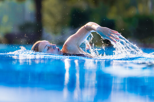 Beautiful woman swimming in swimming pool
