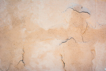 Orange  grey concrete wall, floor with cracks,  a dirty wall with