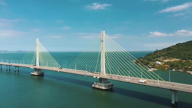 Beautiful aerial orbital shot of Anita Garibaldi bridge above the ocean, located in Laguna, Santa Catarina, Brazil