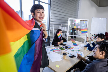 Homosexual Asian businessman with LGBT flag and Successful happy workers with in company  workers...