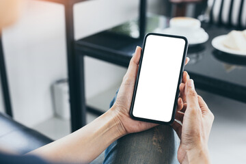cell phone mockup blank white screen.woman hand holding texting using mobile on desk at coffee shop.background empty space for advertise.work people contact marketing business,technology