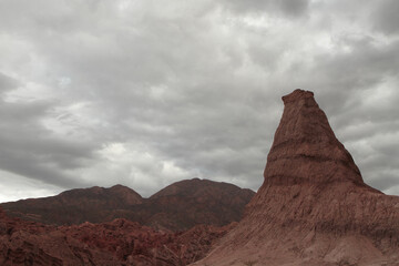 Geology. View of the sandstone and red rocky formation and mountains in the arid desert under a...
