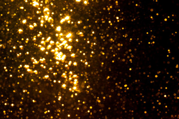 Fototapeta premium Abstract gold bokeh with black background