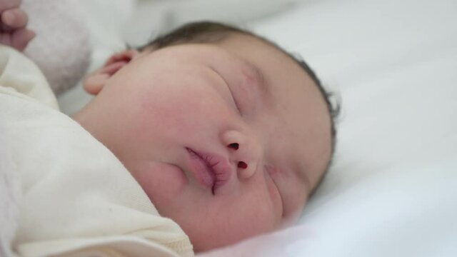 Close up of a Korean mixed new born baby sleeping.