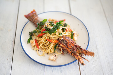 Spaghetti with spicy lobsters in white plate