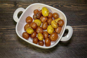 Roasted creamer potatoes with olive oil and herbs to be served as side dish.
