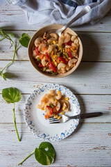 Top view of macaroni pasta served in a plate from a bowl.