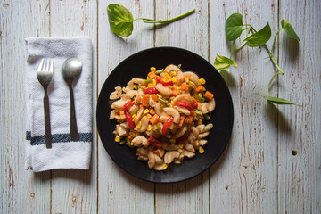 Macaroni pasta with meat and vegetables along with condiments
