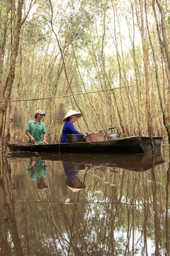 Landscape photo: couple cooking rice in Melaleuca forest (Vietnam)